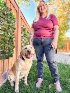 A woman with a labrador dog