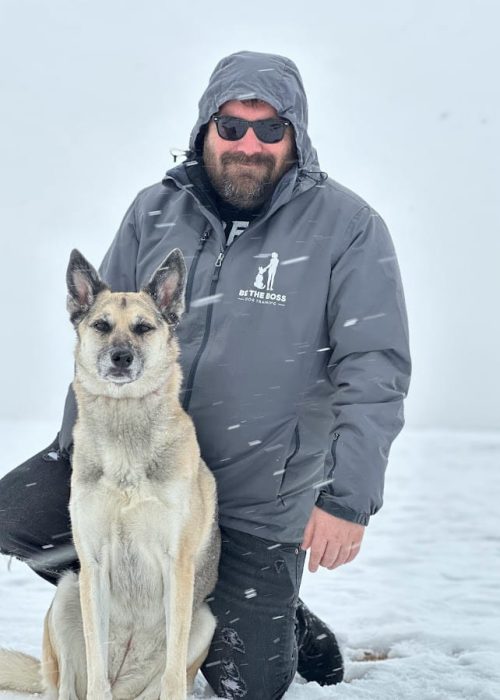 A man with his husky dog.